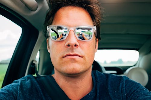 Free Close-up Photography of Man Wearing Sunglasses in Vehicle Stock Photo