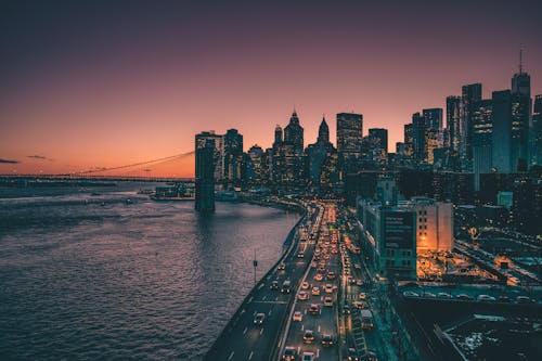 City Skyline Near Body of Water during Night Time