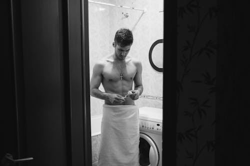 Free Grayscale Photo of a Man in a Bathroom Stock Photo