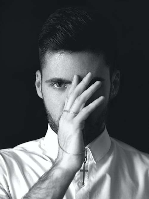 Free Grayscale Photo of a Man Covering his Face Stock Photo