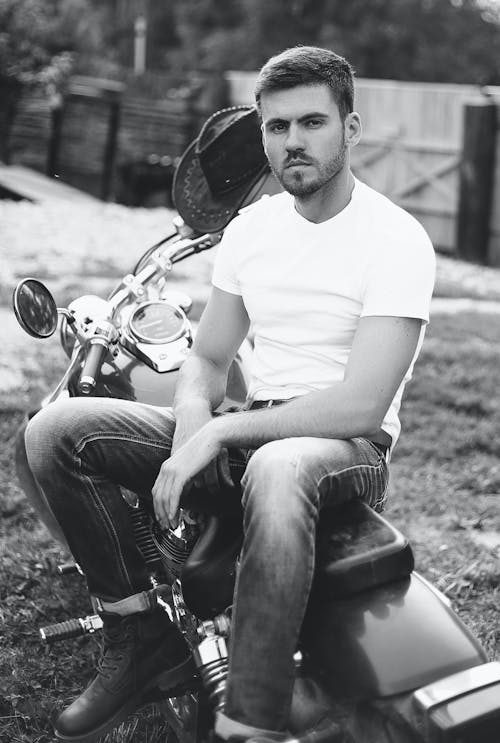 Free Grayscale Photo of a Man Sitting on a Motorcycle Stock Photo