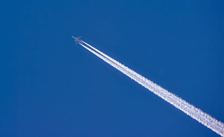 A Jet Leaving Contrails In A Clear Blue Sky