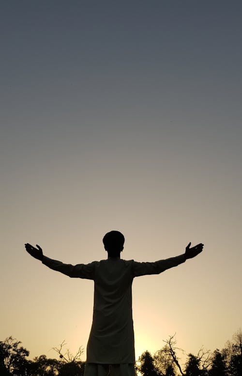 Silhouette of Man With Arms Outstretched