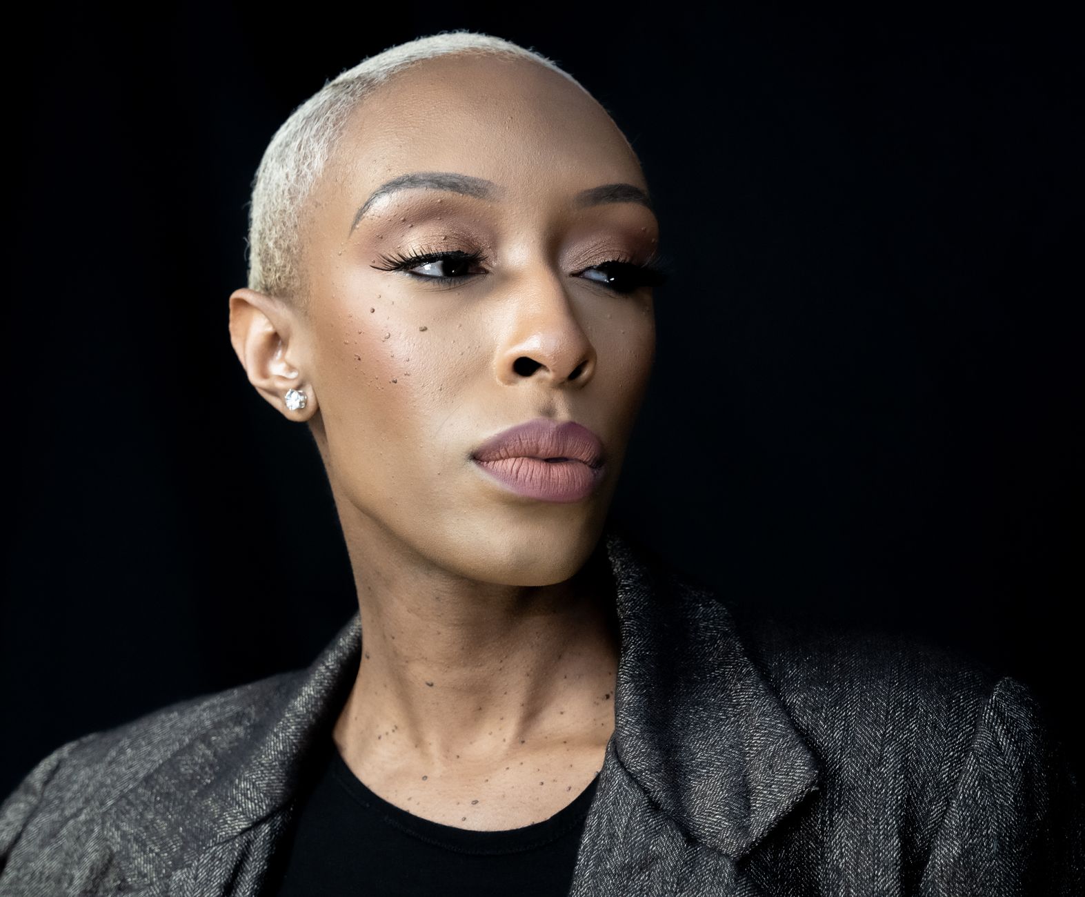 Portrait of a stylish woman posing confidently in a fashionable outfit.