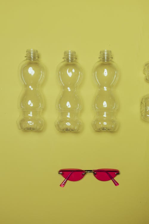 Clear Plastic Bottles on Yellow Surface