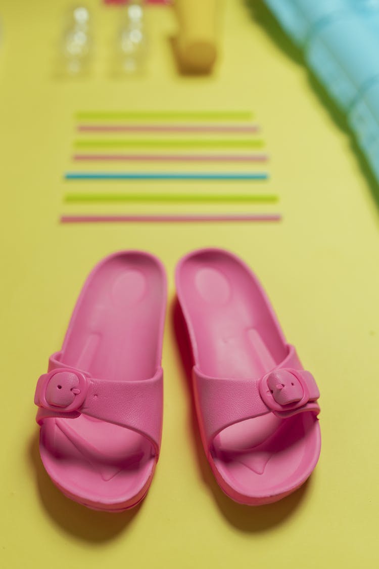 Pink Slide Sandals On Yellow Surface