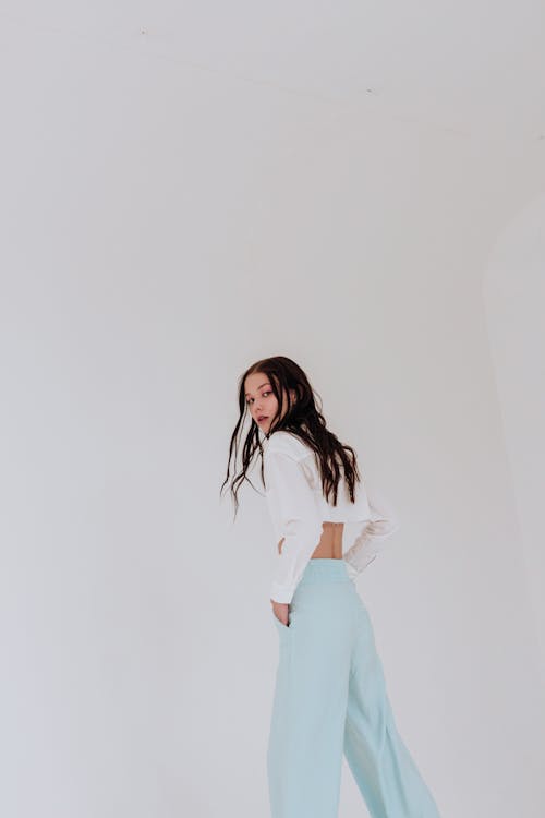 Serious woman in studio on white background