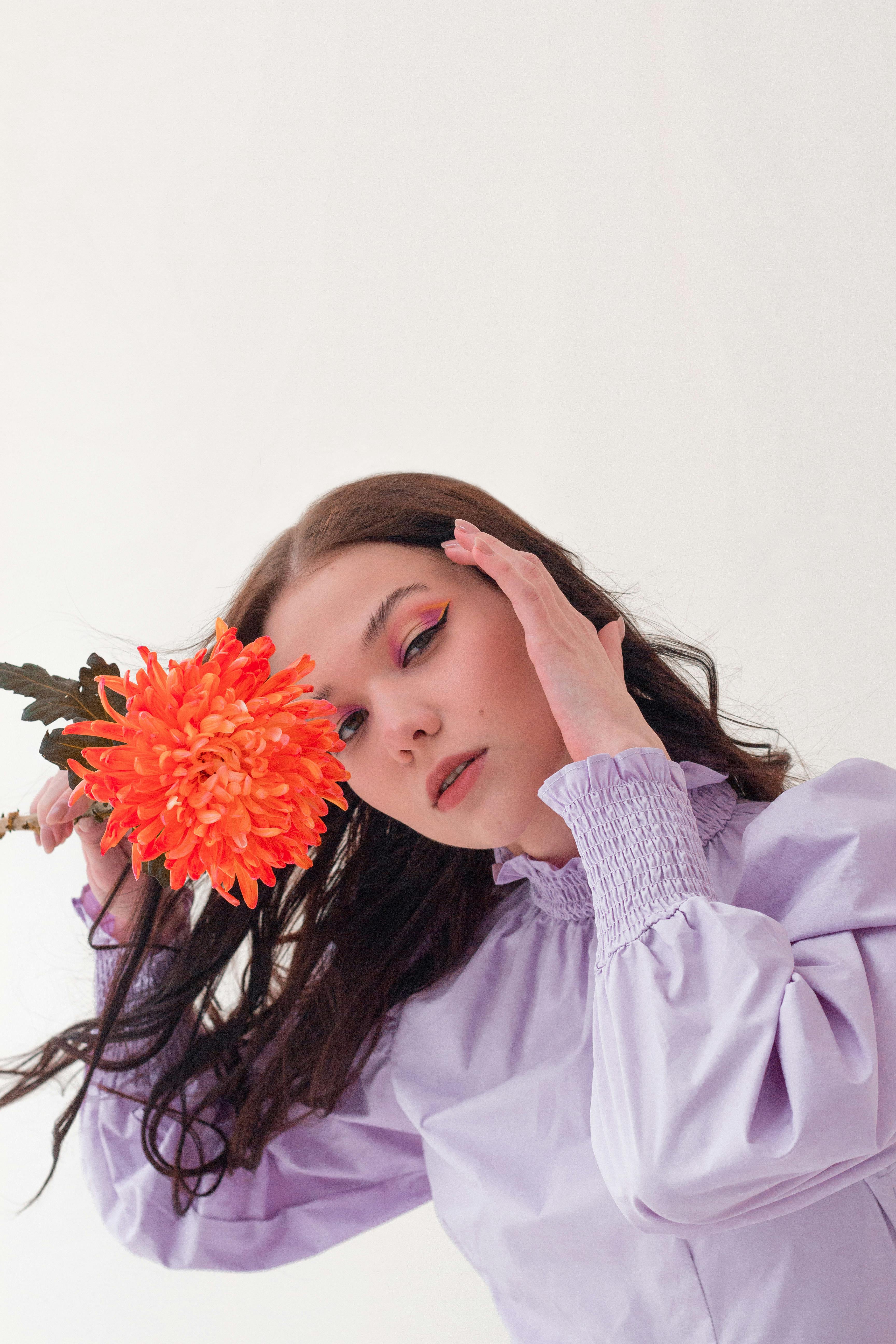 dreamy woman with flower in studio