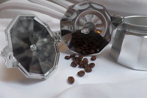 Brown Coffee Beans on Stainless Steel Container