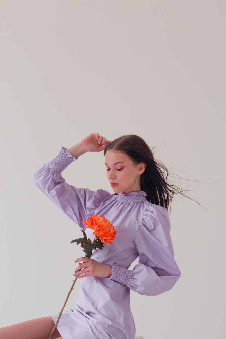 Woman Looking At Delicate Flower