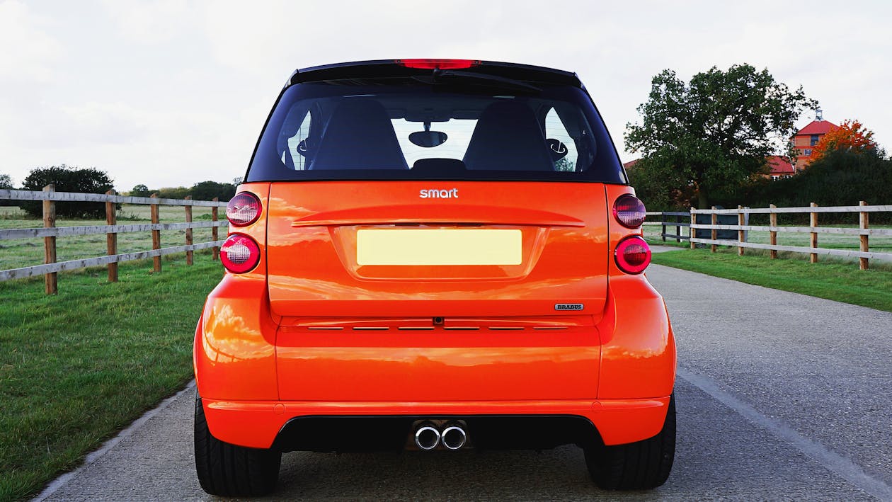 Free Orange Smart Fortwo Car on Road Stock Photo