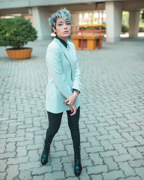 Woman in Gray Blazer and Black Pants Standing on Stone Pavement
