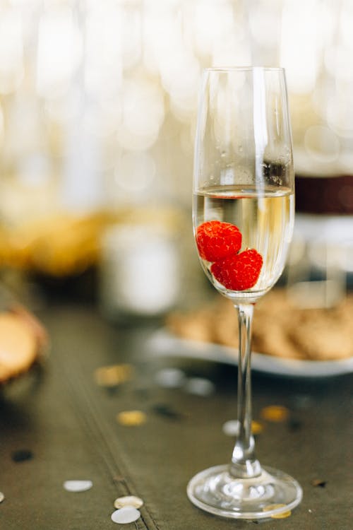 Clear Wine Glass With Red Fruits on Table