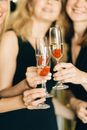 Woman Holding Clear Glasses of Champagne
