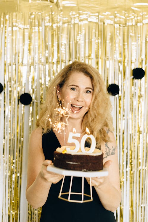 Free Woman in Black Dress Holding a Birthday Cake Stock Photo
