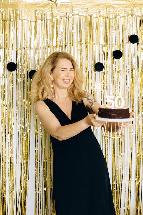 Free Woman in Black Sleeveless Dress Holding a Birthday Cake Stock Photo