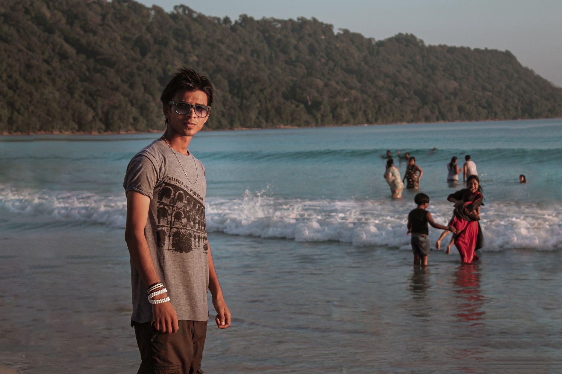 A family enjoys a sunny day at the beach in Andaman and Nicobar Islands, India.