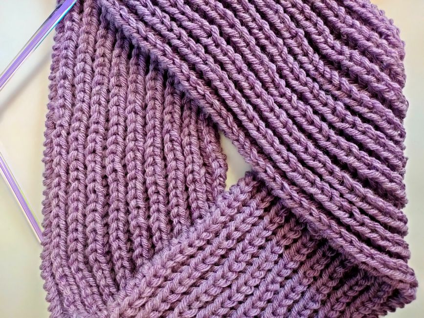 A ribbed cuff robe recovers mechanically through knit ribbing, holding pushed-up sleeves in place long after elastic would go slack.