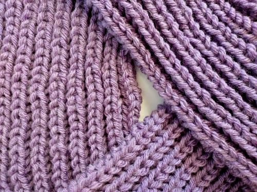 Free Detailed view of purple knitted fabric showcasing its intricate texture and pattern. Stock Photo