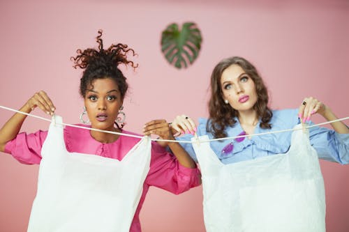 Free Women Holding Plastic Bags on the Clothesline Stock Photo
