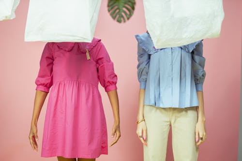 Women Standing Behind the Hanging Plastic Bags