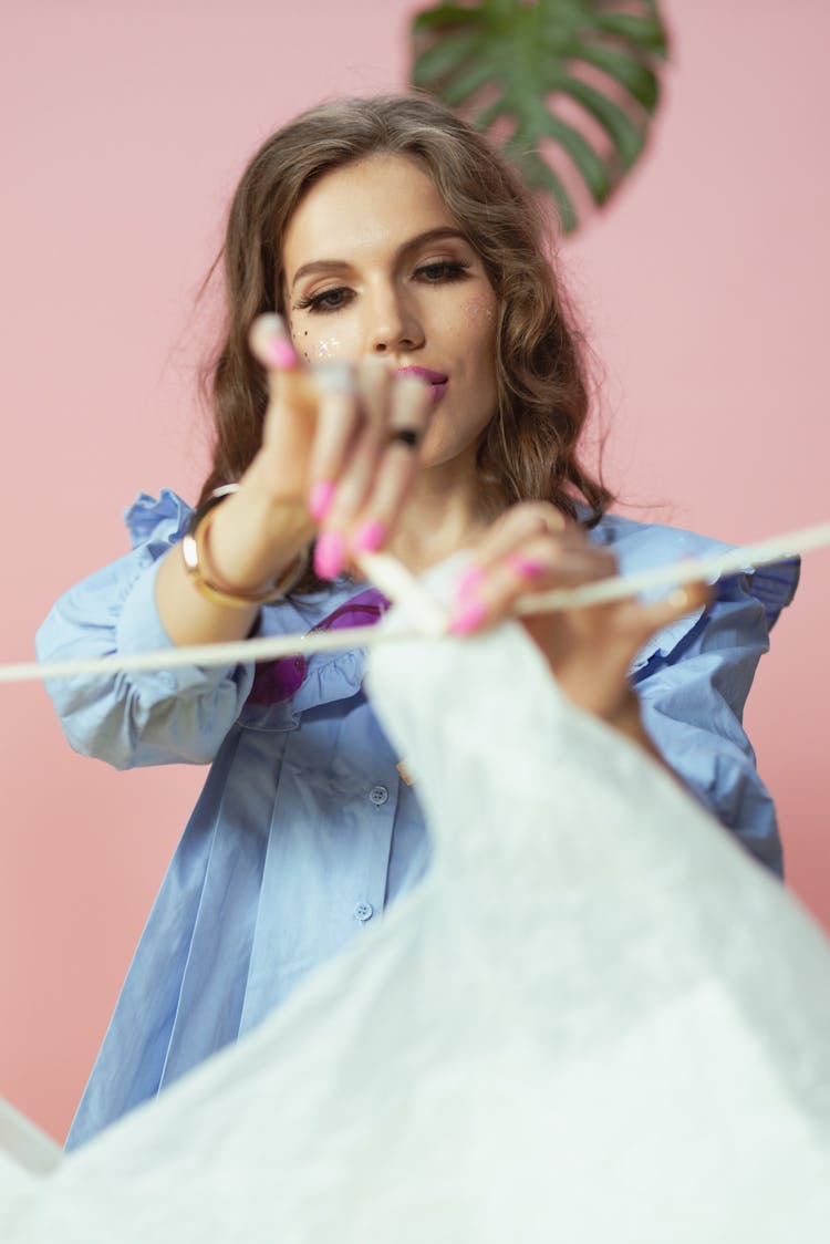 Woman Hanging The Plastic On The Clothesline