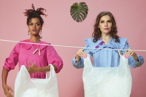 Free Two women pose with zero waste materials in a studio setting. Stock Photo