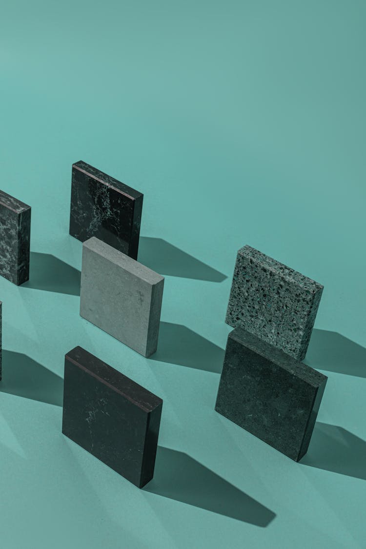 Square Blocks On Teal Surface