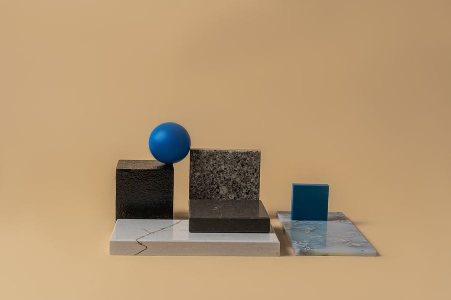 Still-life composition of stone and glass geometric blocks on a warm beige backdrop — Mikhail Nilov on Pexels