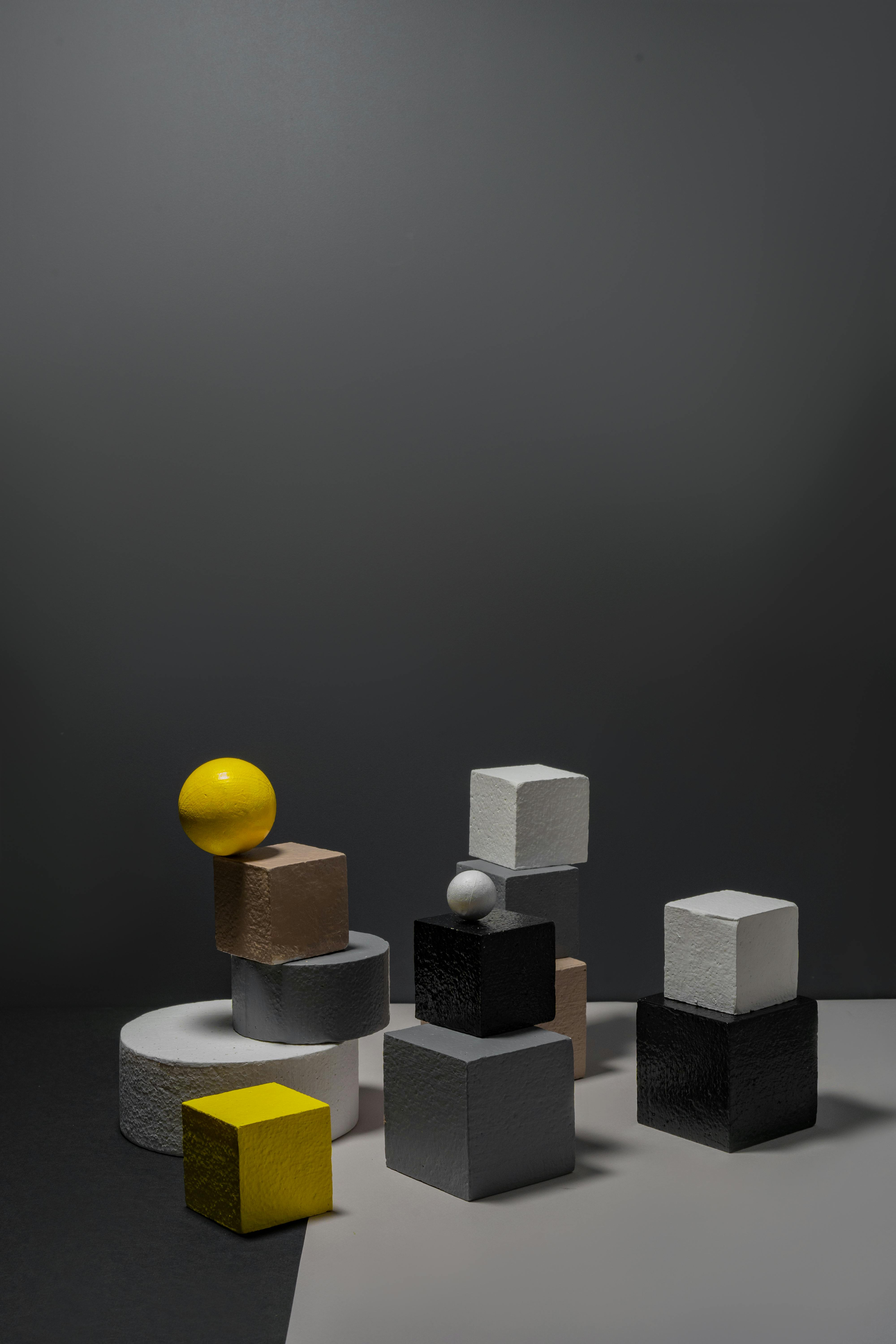 yellow ball on white and gray blocks