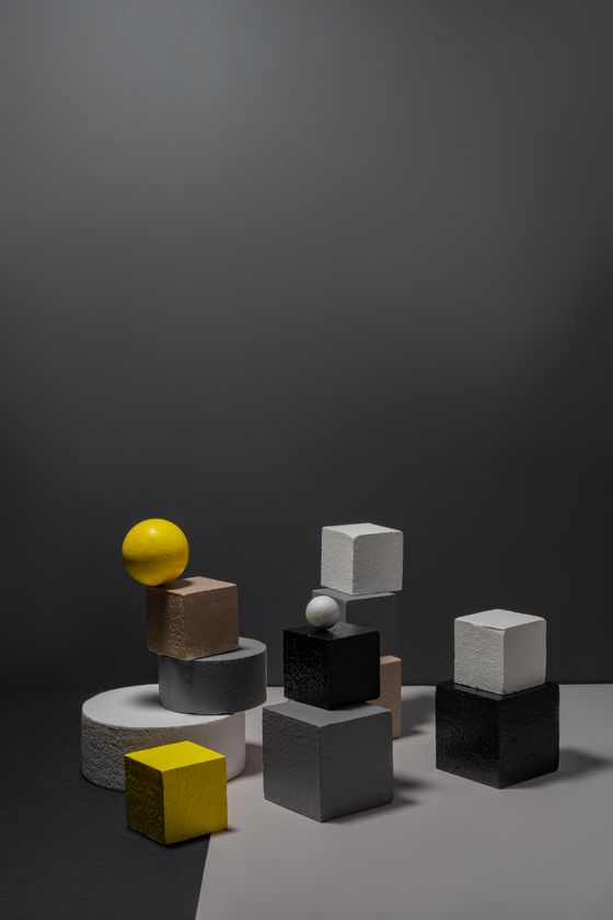Cubes and spheres on a dark set by Mikhail Nilov on Pexels