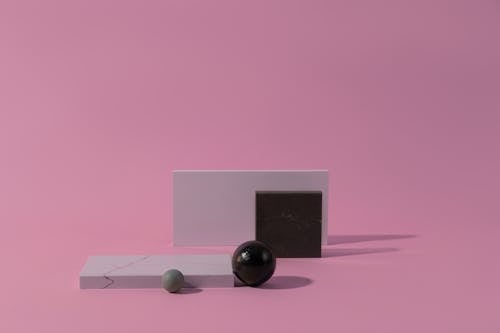 Black and White Marble Objects on a Flat Surface