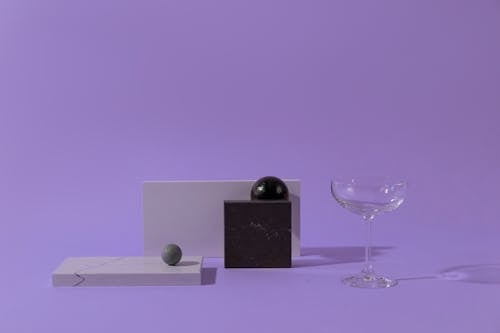 Geometric Shapes and Clear Wine Glass on a Flat Surface