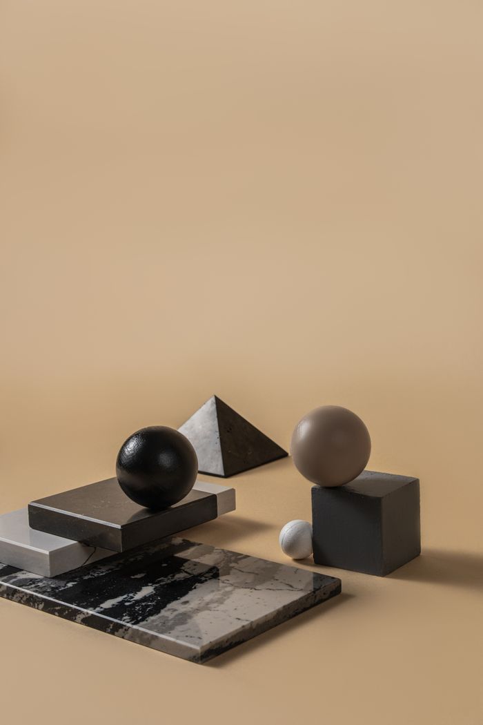 Abstract composition of geometric shapes and marble textures — photo by Mikhail Nilov on Pexels