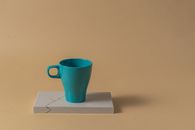 Blue Ceramic Mug on White Paper