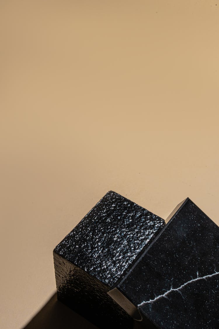 Black Blocks On Brown Surface 