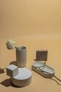 White Flower in White Ceramic Vase Beside Black Framed Eyeglasses on White Table