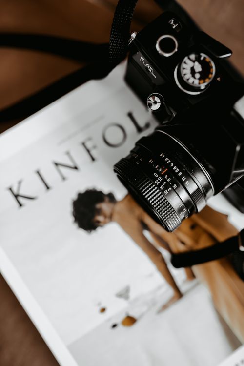 Free Styled flat lay featuring a vintage camera on a Kinfolk magazine, creating a modern aesthetic. Stock Photo