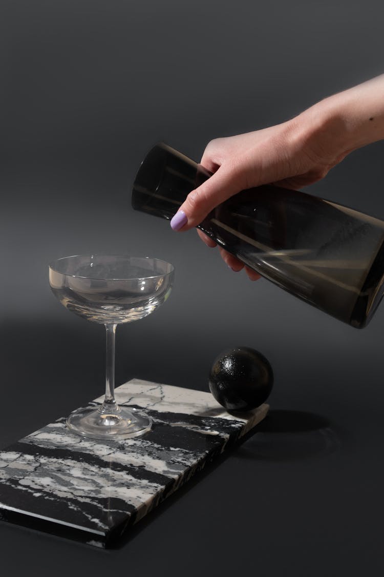 Person Pouring A Liqour On A Cocktail Glass