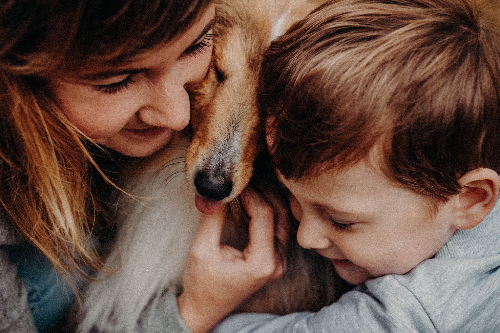 Crop smiling mother with son embracing Collie