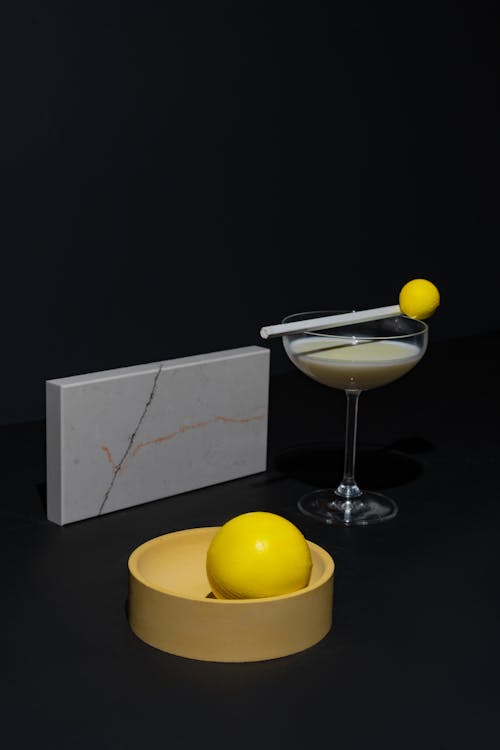 Cocktail Drink in a Glass and Geometrical Figures on Black Background 