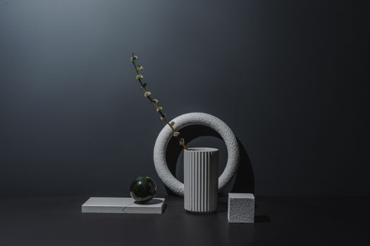 Elegant still life featuring a minimalist arrangement of geometric shapes and textures in a studio setting.