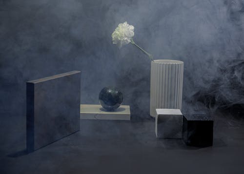Modern Composition of Objects in Different Shapes an a Flower in Smoke