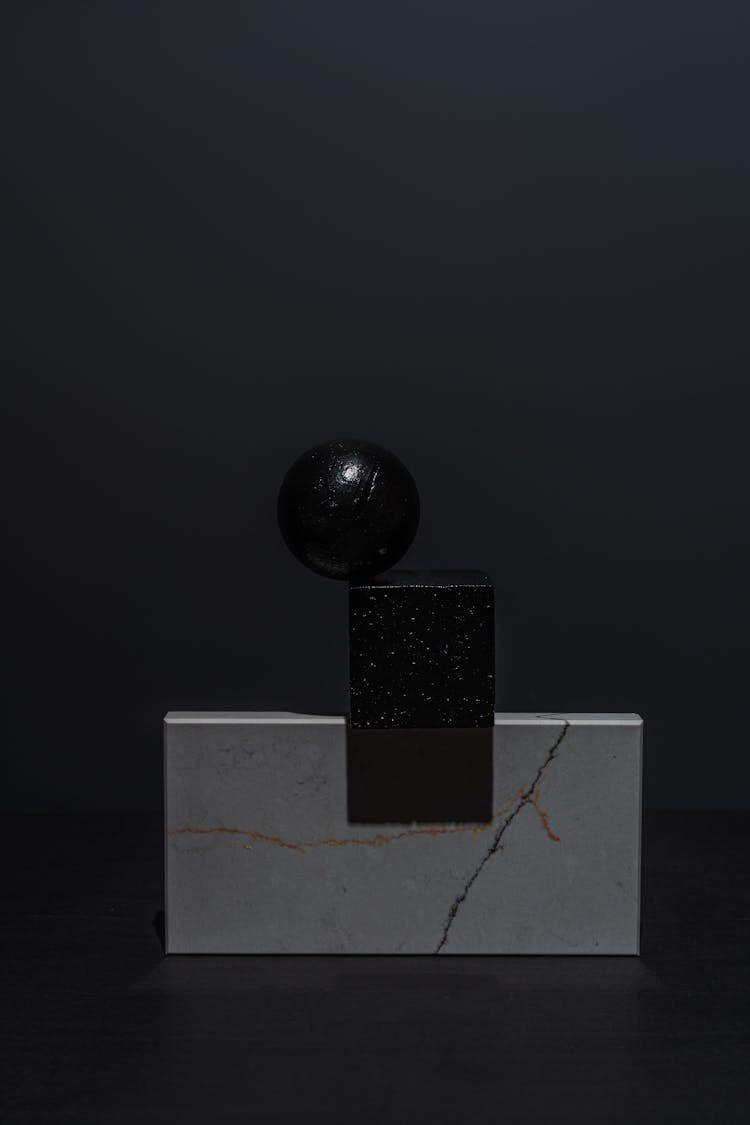 Geometric Shape Objects On A Black Surface