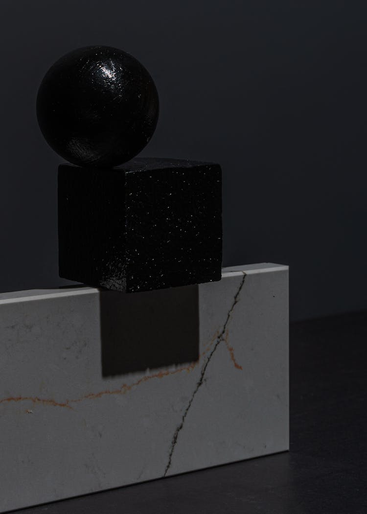 Geometric Shape Objects On A Black Surface