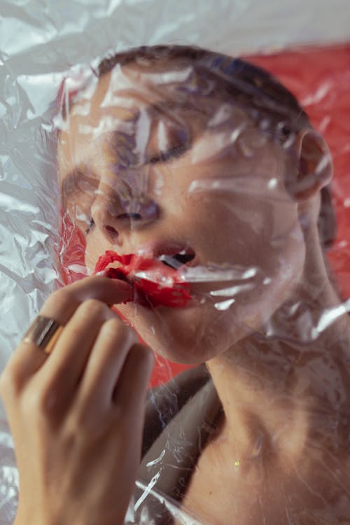 Woman Putting Red Lipstick