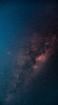 A breathtaking vertical shot of the Milky Way galaxy illuminating the dark night sky.