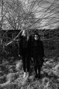 Women Standing Beside the Bare Tree