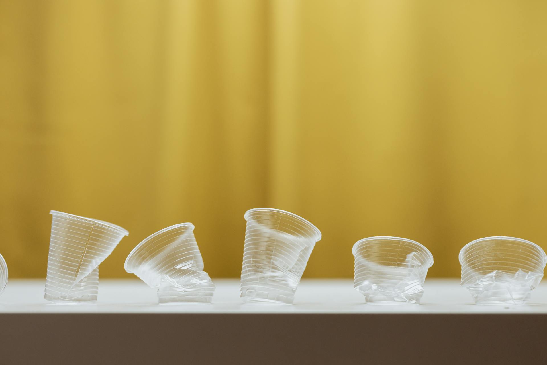 Clear Plastic Cups on White Table