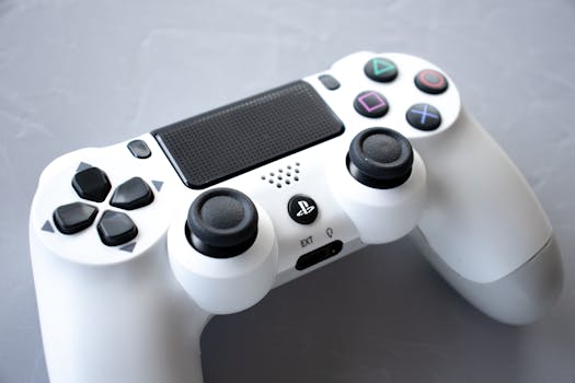 Close-up of a white game controller on a grey surface, emphasizing modern gaming technology.